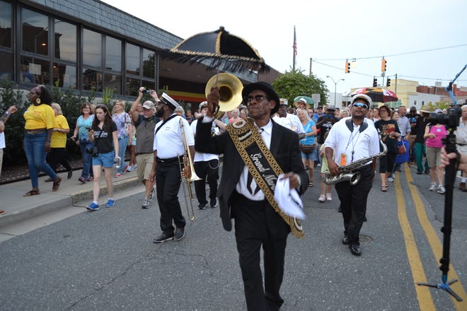 The Treme Brass Band parades down Division Street at the National Folk Festival in Salisbury on Friday night.