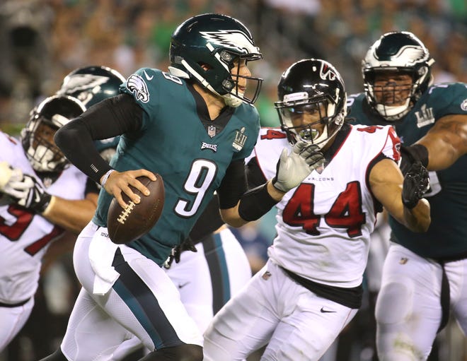 Eagles quarterback Nick Foles is chased by Atlanta's Vic Beasley Jr. in Philadelphia's 18-12 win in the NFL season-opener in Thursday Night Football at Lincoln Financial Field.