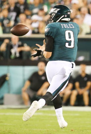 Eagles quarterback Nick Foles receives a pass from receiver Nelson Agholor on a third-quarter scoring drive in Philadelphia's 18-12 win in the NFL season-opener in Thursday Night Football at Lincoln Financial Field.