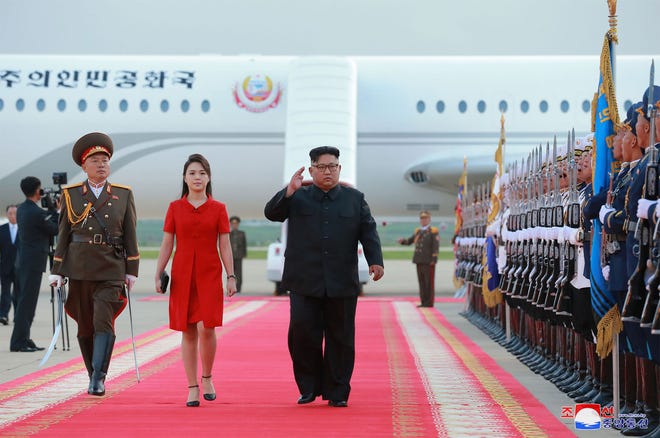 In this June 20 photo released by North Korea's official Korean Central News Agency shows North Korean leader Kim Jong Un and his wife Ri Sol Ju arriving at Pyongyang International Airport in Pyongyang, following their trip to Beijing.