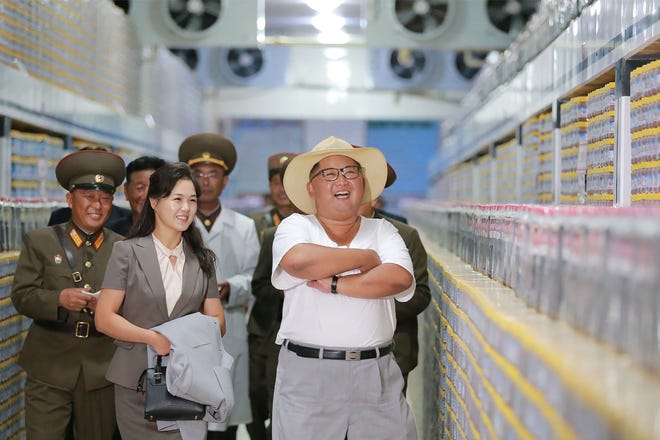 This undated picture released by North Korea's official Korean Central News Agency on August 8, 2018 via KNS shows North Korean leader Kim Jong Un inspecting the Kumsanpho Fish Pickling Factory with his wife Ri Sol Ju in South Hwanghae Province, North Korea.