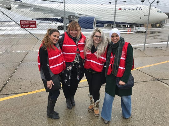Sumaiya Ahmed Sheikh, left, poses with Phoebe Hopps, Stephanie Kenner and Fatima Salman for a photo at Detroit Metro Aiport, where they organized a January 2017 protest against the Trump administration's travel ban.