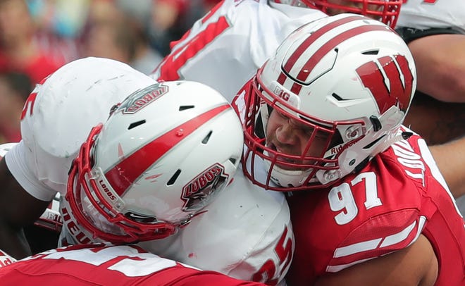 Wisconsin defensive end Isaiahh Loudermilk  wraps up New Mexico running back Tyrone Owens earlier this season.