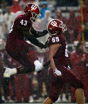 Indiana Hoosiers linebacker Dameon Willis Jr. (43) celebrates with defensive lineman Gavin Everett (69) after Everett made a tackle during the game against Virginia at Memorial Stadium in Bloomington, Ind., on Saturday, Sept. 8, 2018.