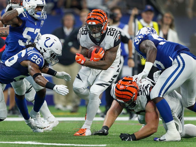 Cincinnati Bengals running back Joe Mixon (28) runs into the Colts secondary and Indianapolis Colts defensive back Clayton Geathers (26) in the second half of their game at Lucas Oil Stadium on Sept. 9, 2018. The Indianapolis Colts lost to the Cincinnati Bengals 34-23.