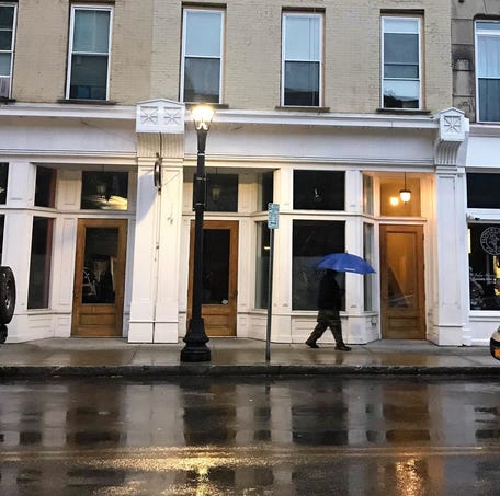A man walks in the rain on Main Street in the City of Poughkeepsie as seen on Friday, Sept. 7, 2018.