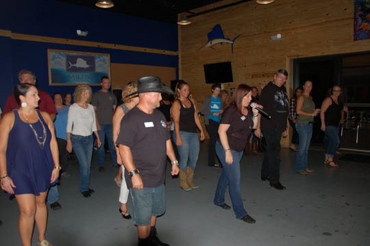 The sixth annual Wild Roses Workshop & Social Dances is Saturday at the River Walk Center in Fort Pierce. The team is pictured here line dancing at Sailfish Brewing Company.