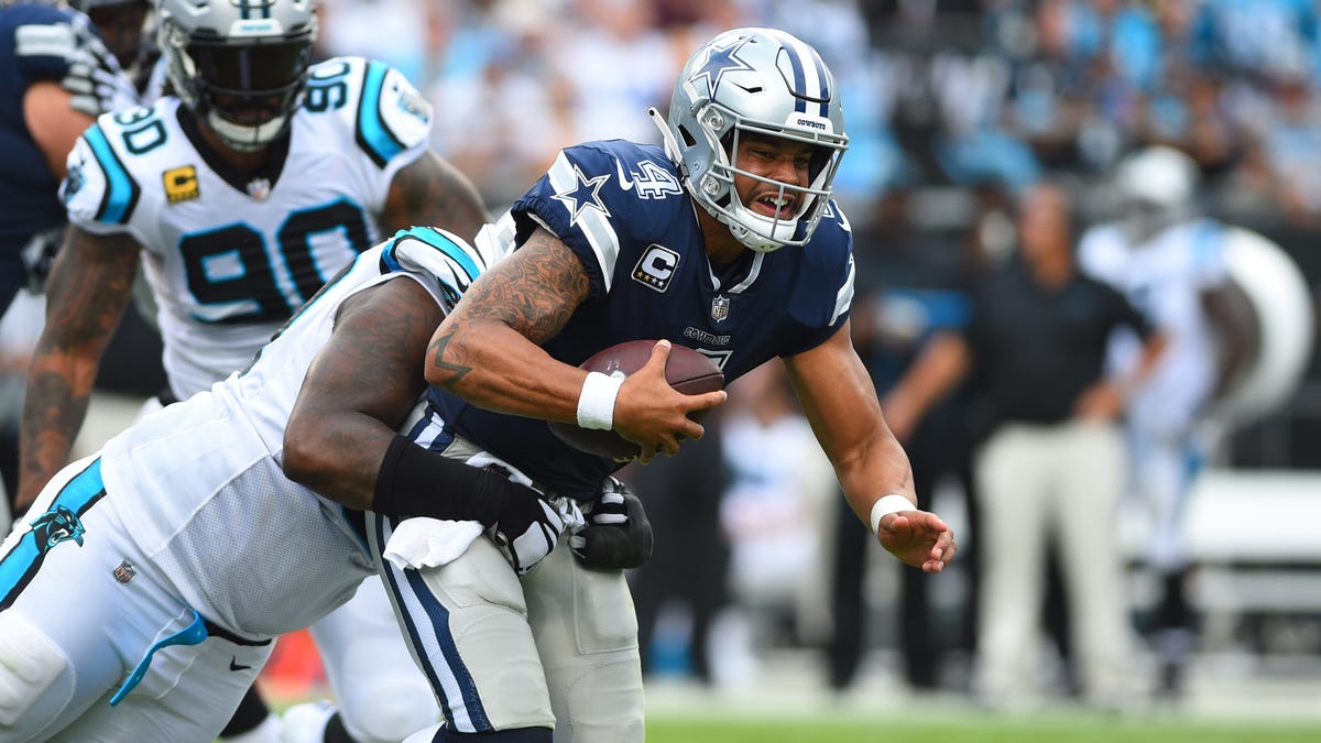 Dallas Cowboys quarterback Dak Prescott (4) is sacked by Carolina Panthers defensive tackle Kawann Short (99) in the second quarter at Bank of America Stadium.