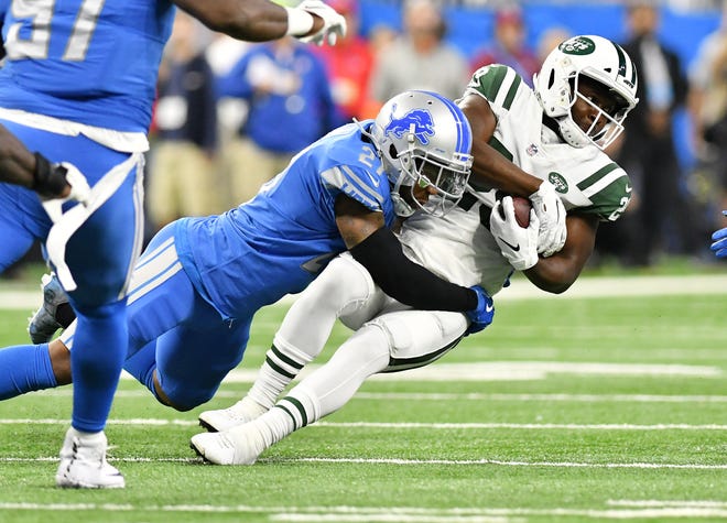 Lions safety Glover Quin tackles Jets running back Bilal Powell in the first quarter.