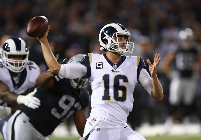 Los Angeles Rams quarterback Jared Goff throws as Oakland Raiders nose tackle P.J. Hall looks on during the first half.