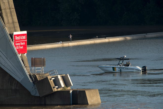 Conservation officers with the Indiana Department of Natural Resources search the Ohio River near the Newburgh Dam for a missing fisherman, Steven O. Burks, 45, of Owensboro, Ky., Monday evening. Burks is missing after his fishing boat submerged at the dam as he and a friend, Paul W. Warrenfeltz, 48, also of Owensboro, were catching bait fish Sunday afternoon. Warrenfeltz was able to reach the dam safely. A sign on the dam reads "Restricted – Keep back 150 feet."