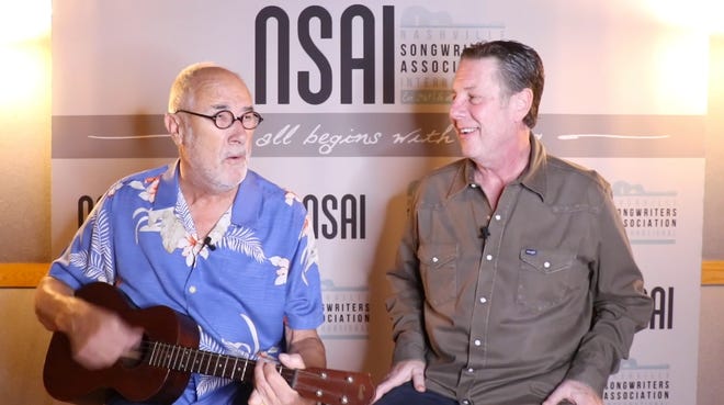 Roger Cook, left, performs for Bart Herbison.