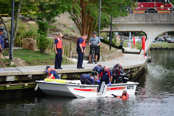 A Salisbury Fire Department diver helps remove a body that was found in the Wicomico River near South Division Street Bridge around 12:30 p.m.