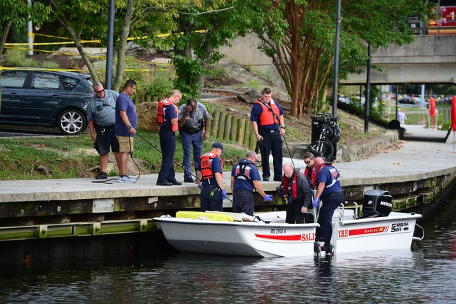 A Salisbury Fire Department diver helps remove a body that was found in the Wicomico River near South Division Street Bridge around 12:30 p.m.