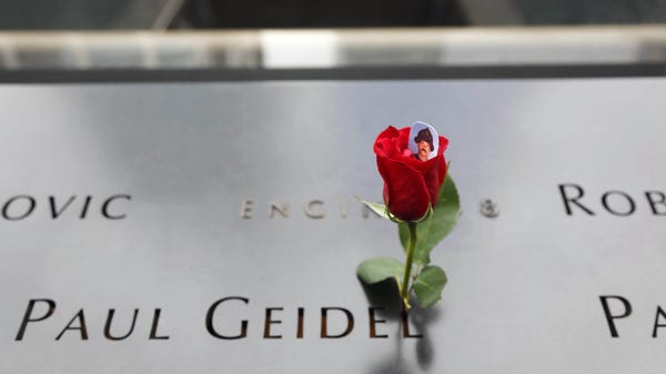 A flower is placed on the South Tower Memorial by...