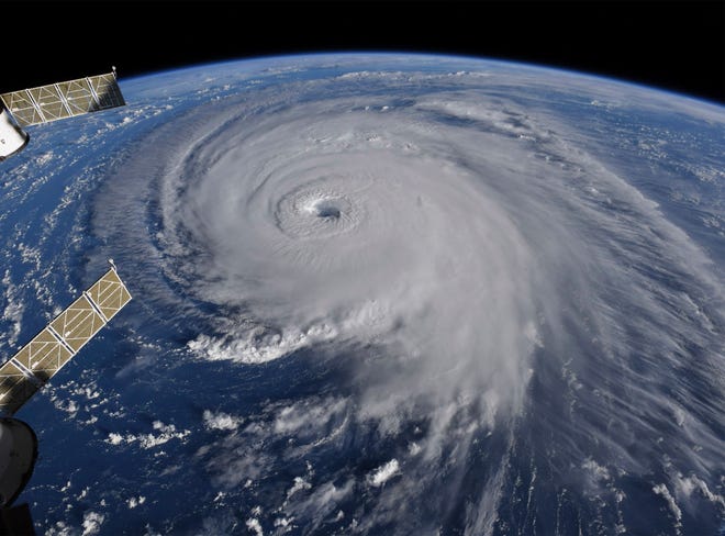 This image provided by NASA shows Hurricane Florence from the International Space Station on Wednesday, Sept. 12, 2018, as it threatens the U.S. East Coast. Hurricane Florence is coming closer and getting stronger on a path to squat over North and South Carolina for days, surging over the coast, dumping feet of water deep inland and causing floods from the sea to the Appalachian Mountains and back again.  (NASA via AP)