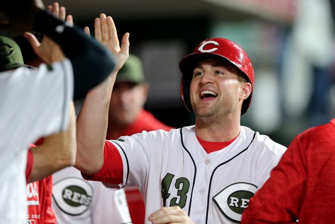 Cincinnati Reds right fielder Scott Schebler (43) is congratulated after scoring in the fifth inning  during a baseball game between the Los Angeles Dodgers and the Cincinnati Reds, Tuesday, Sept. 11, 2018, at Great American Ball Park in Cincinnati. 