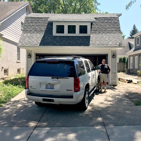 Builder Al Shaheen stands in front of a garage in...