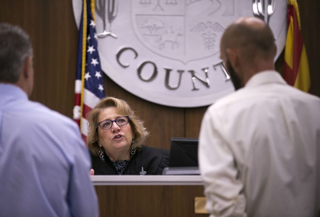 Judge Anna Huberman speaks with a tenant (right) as Scott Clark, an attorney for the landlord, looks on during an eviction hearing at the Country Meadows Justice Court in Tolleson on Aug. 15, 2018. "I think the problems are structural," Huberman says of the county's evictions process.