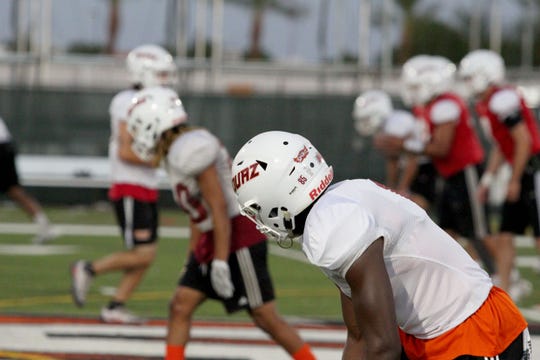 OUAZ players get set on the line of scrimmage before the snap at practice on Tuesday night in Surprise on Sept. 11, 2018.