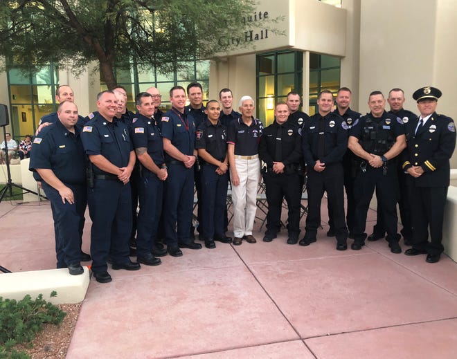 Mesquite law enforcement officers and firefighter join the Exchange Club of Mesquite's Paul Benedict following the 9/11 remembrance ceremony at Mesquite City Hall