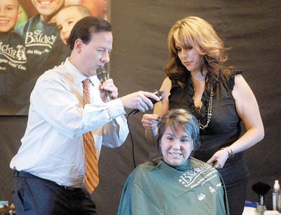 Channel 9-KTSM Chief Meteorologist Chuck DeBroder cuts hair at an event to raise money to fight childhood cancer in 2013.