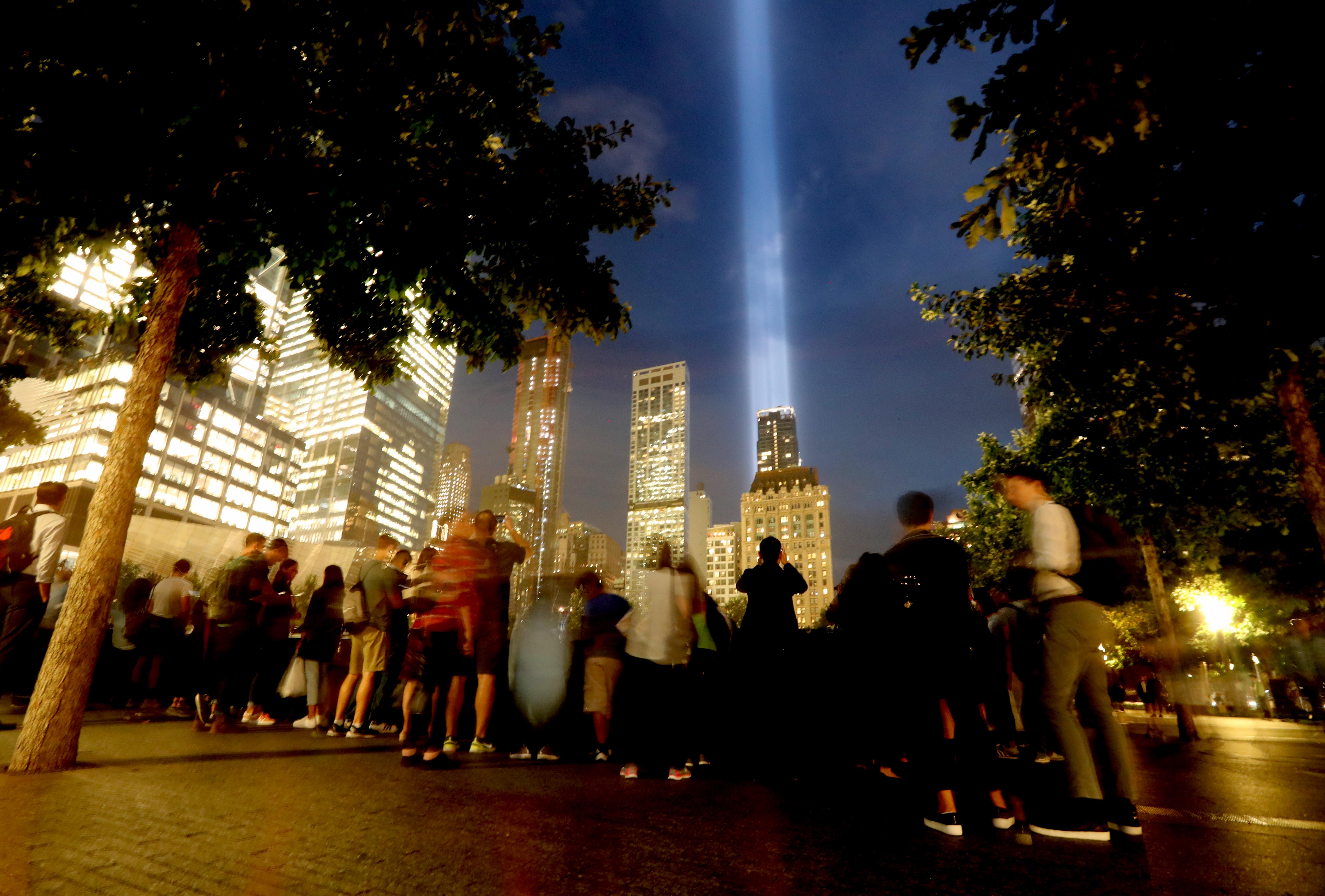 Visitors to the 9/11 Memorial in New York City take in the Tribute in Light on Sept. 11, 2018.