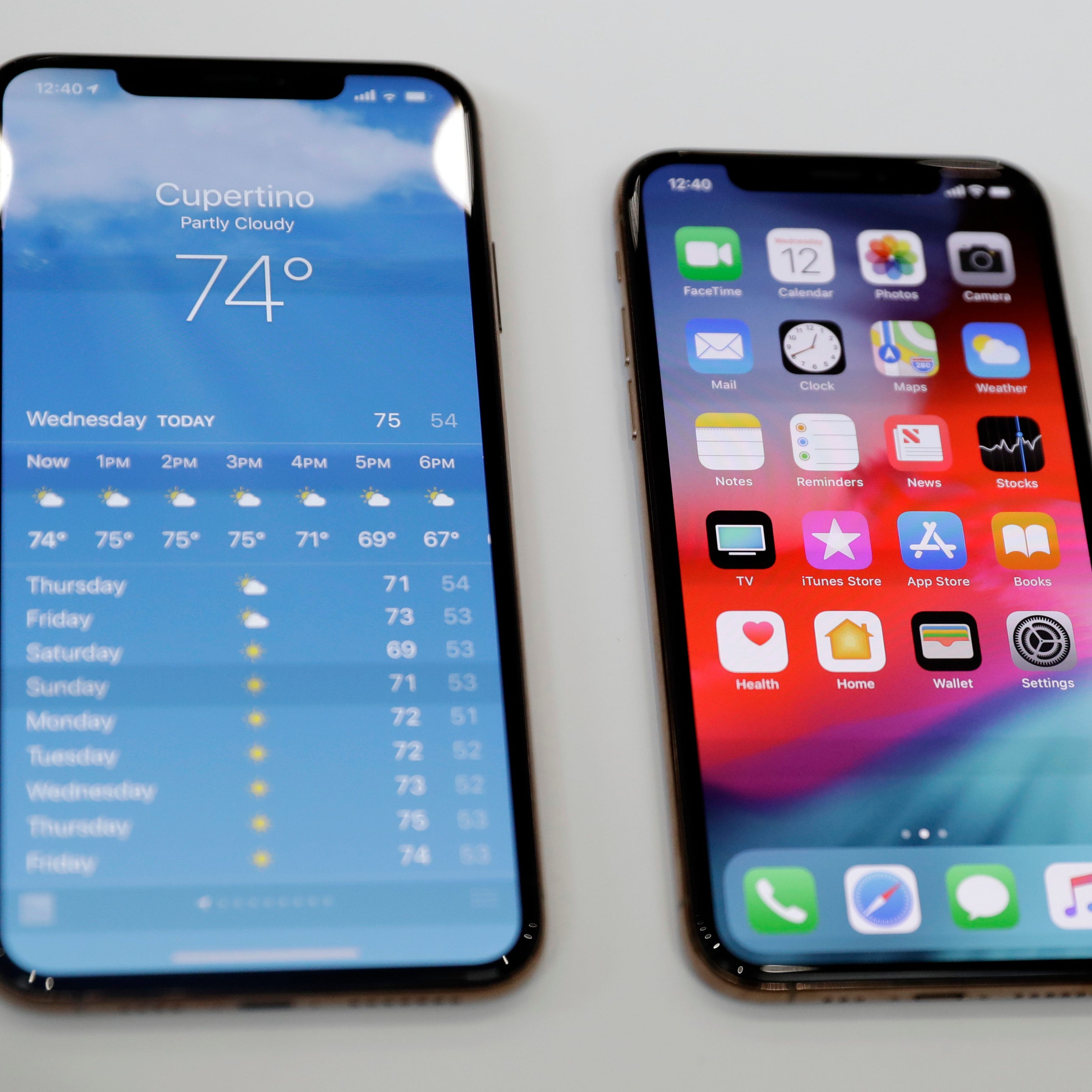 The iPhone XS, right, and XS Max are displayed side to side during an event to announce new products at Apple headquarters Wednesday, Sept. 12, 2018, in Cupertino, Calif.