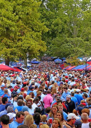 Fans gather in The Grove to await the football team's "Rebel Walk" to the stadium before a game in 2017. The Grove, approximately 10 acres located in the middle of the Ole Miss campus in Oxford, is recognized as one of the nation's top tailgating sites.