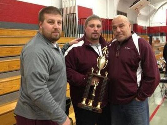 Frank DiPiano (center) with brother Mike (left) and his dad after Nutley won a county wrestling title in 2013.