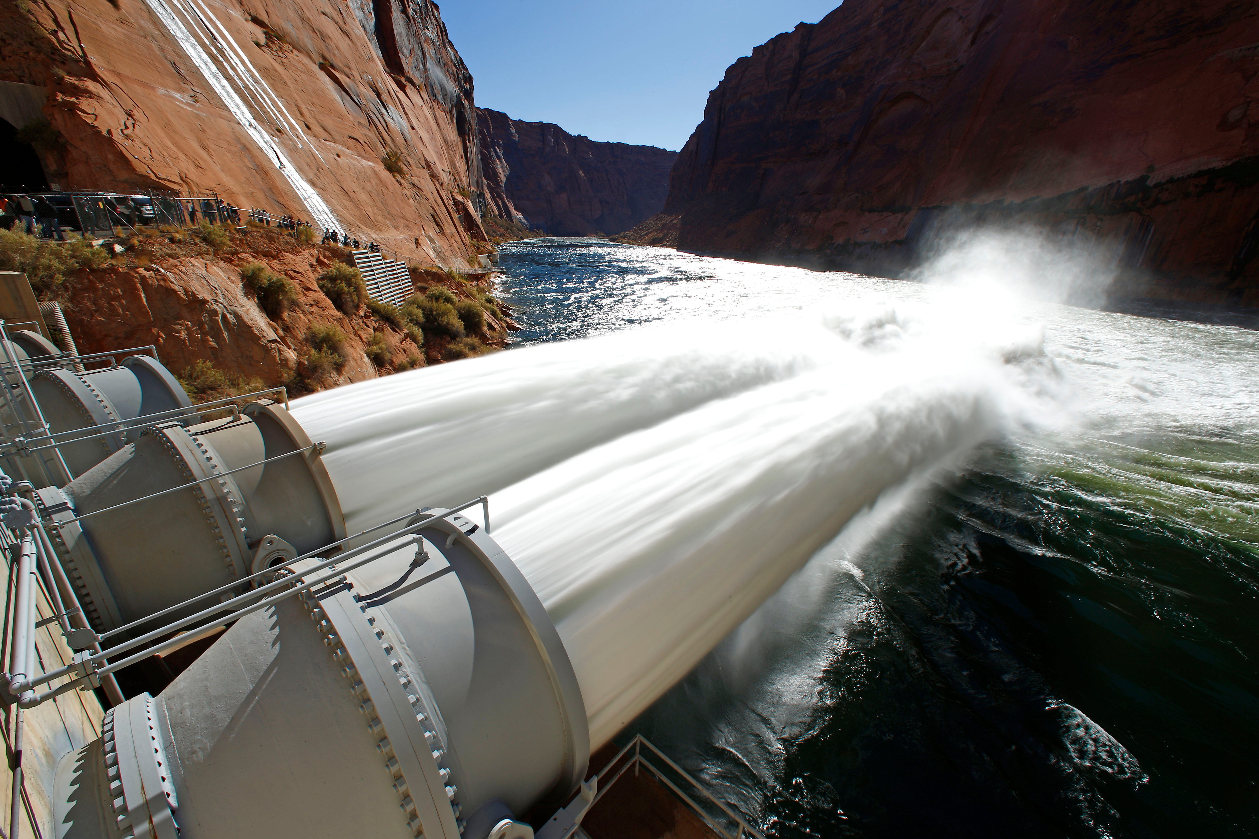 Water shoots out of the turbines of Glen Canyon Dam during an experimental 5-day high-flow release to help restore beaches along the Colorado River in Grand Canyon in 2012.