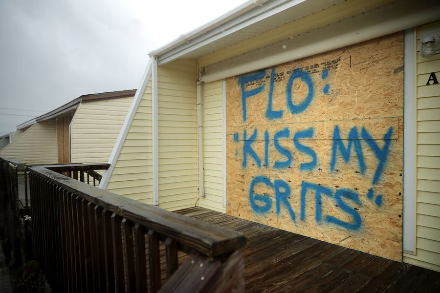 A spray painted message is left on a boarded up condominium as the outer bands of Hurricane Florence being to affect the coast Sept. 13, 2018 in Atlantic Beach, United States. Coastal cities in North Carolina, South Carolina and Virginia are under evacuation orders as the Category 2 hurricane approaches the United States. 