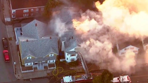 In this image take from video provided by WCVB in Boston, firefighters battle a large structure fire in Lawrence, Mass, a suburb of Boston, Thursday, Sept. 13, 2018. Emergency crews are responding to what they believe is a series of gas explosions that have damaged homes across three communities north of Boston.