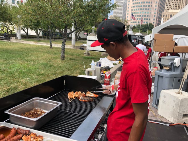 Demarco Patrick grills shrimp skewers and lobster tails at the Great American Lobster Fest taking place this weekend at Hart Plaza.