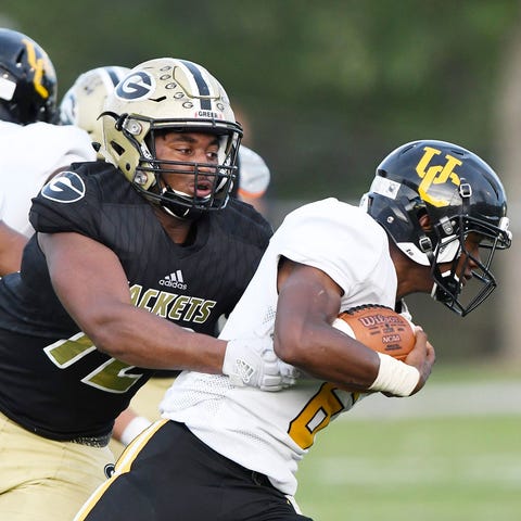 Greer defensive end Jakyre Kerns, left, investigat