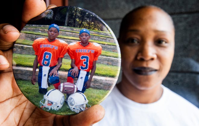 Nataki Ruggs, mother of Henry Ruggs III, a receiver for Alabama, and Kevontae' Ruggs, a linebacker for Ole Miss, holds a button on Friday September 14, 2018 that shows her sons when they were young.
