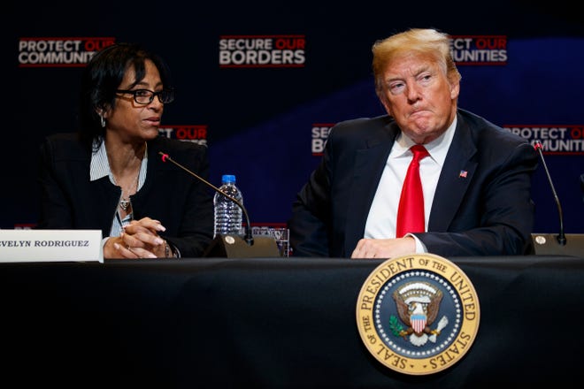 President Donald Trump listens as Evelyn Rodriguez, left, tells the story of her daughters murder by the MS-13 street gang at a roundtable event on immigration policy at Morrelly Homeland Security Center, Wednesday, May 23, 2018, in Bethpage, N.Y.