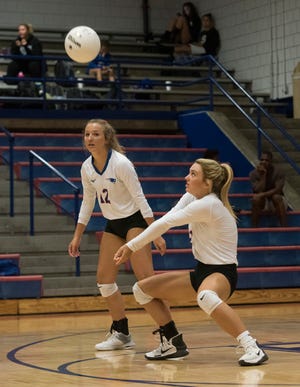 Pace High School’s Livi Bradley, (No. 2) digs a Washington High serve as her teammate, Carley Rogers, (No. 12) looks on during a match earlier this season. The Patriots defeated the Wildcats , 25-8, 26-24, 25-14.