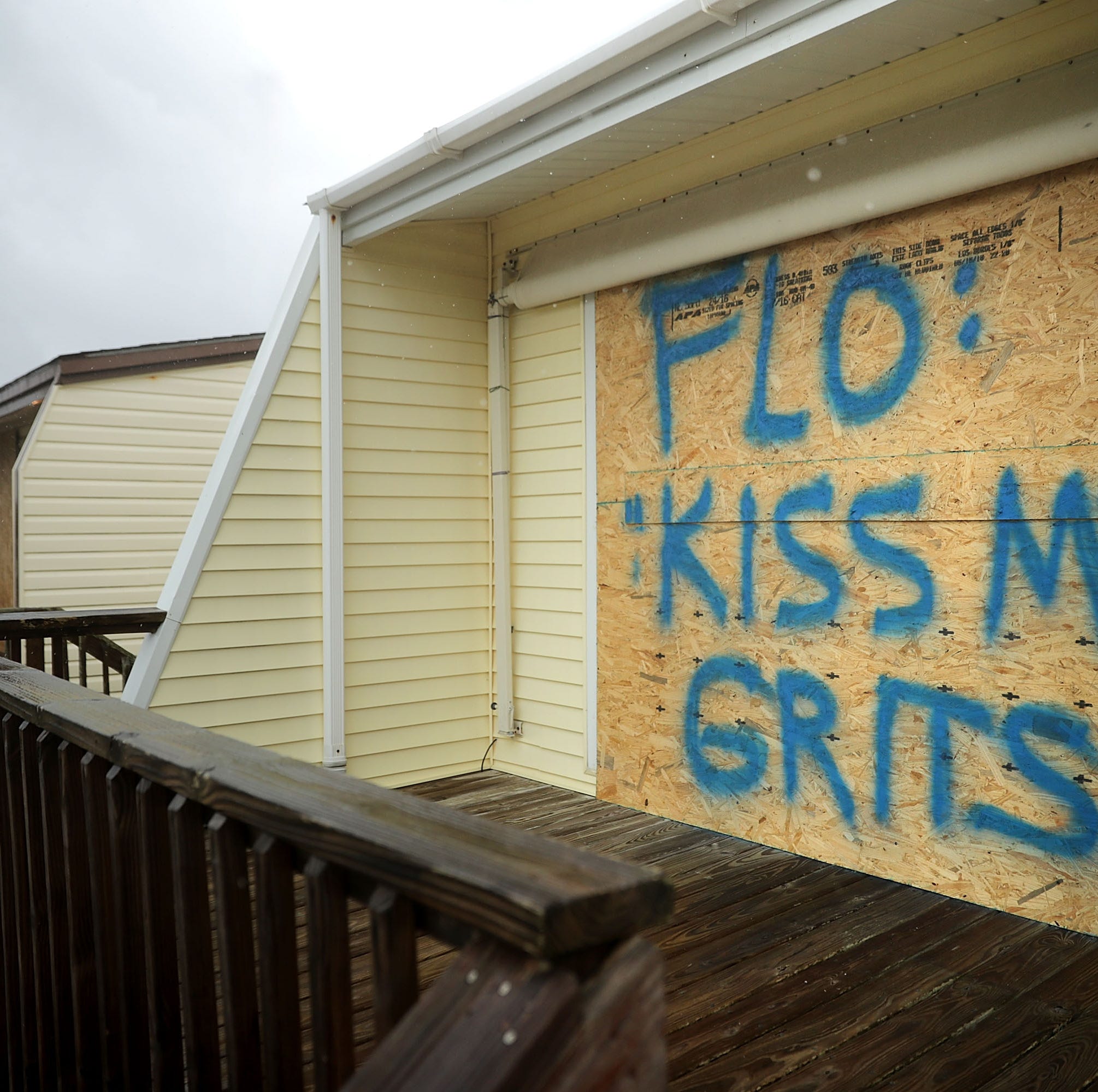 A spray painted message is left on a boarded up condominium as the outer bands of Hurricane Florence being to affect the coast September 13, 2018 in Atlantic Beach, United States.