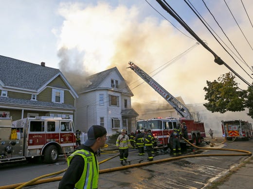 Firefighters battle a fire in a house in Lawrence, Mass. on Sept. 13 2018. 