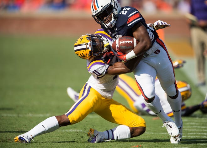 Auburn’s Shaun Shivers (25) is shoved out of bounds by LSU’s Terrence Alexander (11) at Jordan-Hare Stadium in Auburn, Ala., on Saturday, Sept. 15, 2018. Auburn leads LSU 14-10 at halftime.