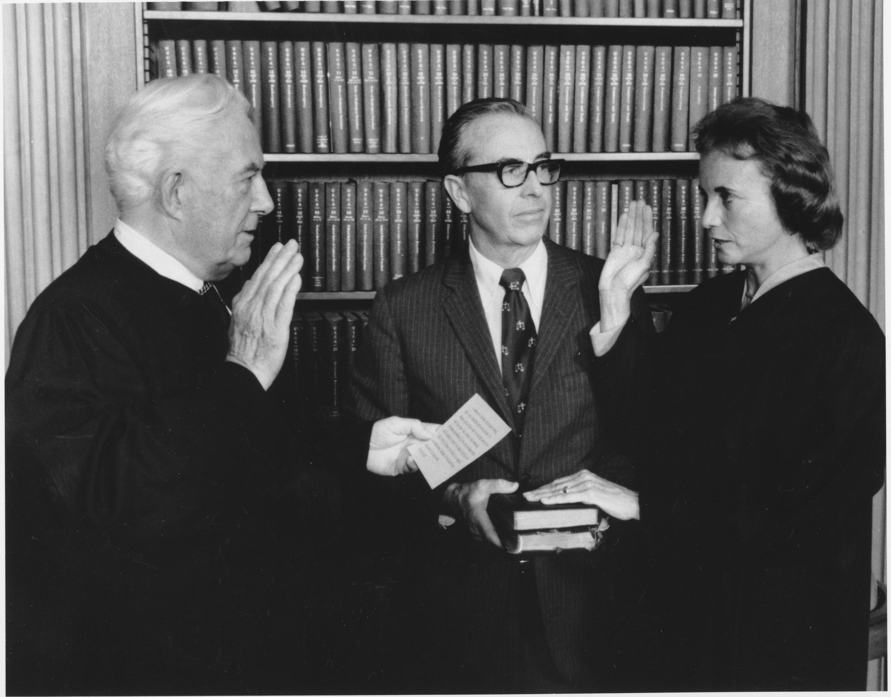 Sandra Day O'Connor is sworn in as an Associate Justice by Chief Justice Warren Burger at the Supreme Court in Washington, D.C. on Friday, Sept. 25, 1981.  Holding two family bibles, at center, is husband John J. O'Connor.