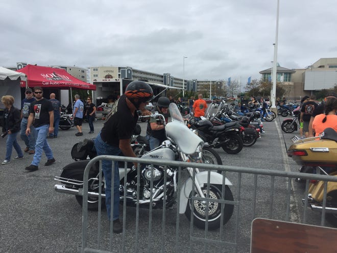 A biker dismounts his motorcycle at Ocean City BikeFest on Saturday.
