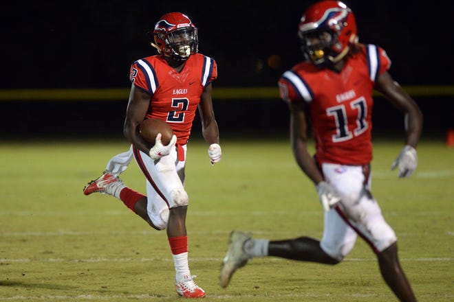 St. Lucie West Centennial's Dwight Toombs (11) leads the way as teammate Tahron Sims (2) heads downfield against Melbourne on Friday, Sept. 14, 2018 at South County Regional Stadium. Centennial won 54-0 for its first 4-0 start in 15 years.