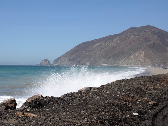 STAR FILE PHOTO Waves crash onto the shoulder of Pacific Coast Highway south of Mugu Rock.