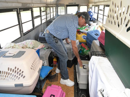 Animal crates fill East Tennessee resident and truck driver Tony Alsup's school bus that he purchased to rescue shelter animal. On Monday he drove the bus to South Carolina to pick up dogs and cats from shelters in the path Hurricane Florence. Alsup transported 64 dogs and cats to Alabama and plans to go back.
