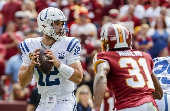 Indianapolis Colts quarterback Andrew Luck (12) drops back to pass as he's pressured by Washington Redskins cornerback Fabian Moreau (31) during the first half of action. The Indianapolis Colts play the Washington Redskins at FedEx Field in Landover, MD., Sunday, Sept. 16, 2018.