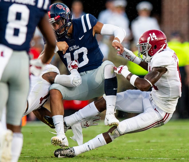 Alabama defensive back Deionte Thompson (14) and defensive back Xavier McKinney (15) tackle Ole Miss quarterback Jordan Ta'amu (10) causing a fumble In first half action in Oxford, Ms., on Saturday September 15, 2018.