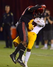 San Diego State safety Trenton Thompson hits ASU receiver Frank Darby late in the fourth quarter, a play that was originally ruled a catch until a review overturned the call.