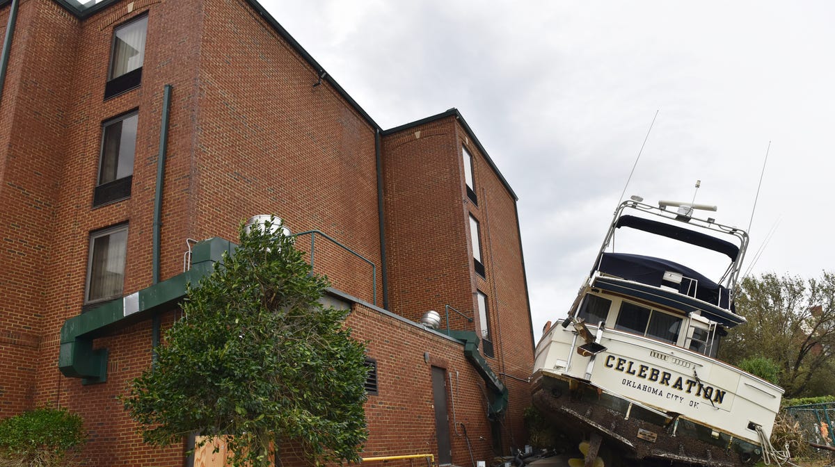 A yacht rests on the side of a downtown hotel in New Bern, N.C., Sunday, Sept. 16, 2018. Hurricane Florence brought heavy rains and winds to the area. 